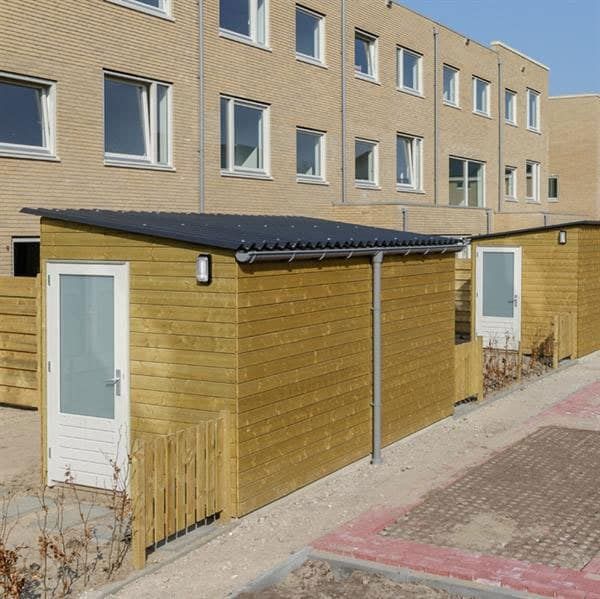 Berging met houtkleur en witte deur bij een flatgebouw