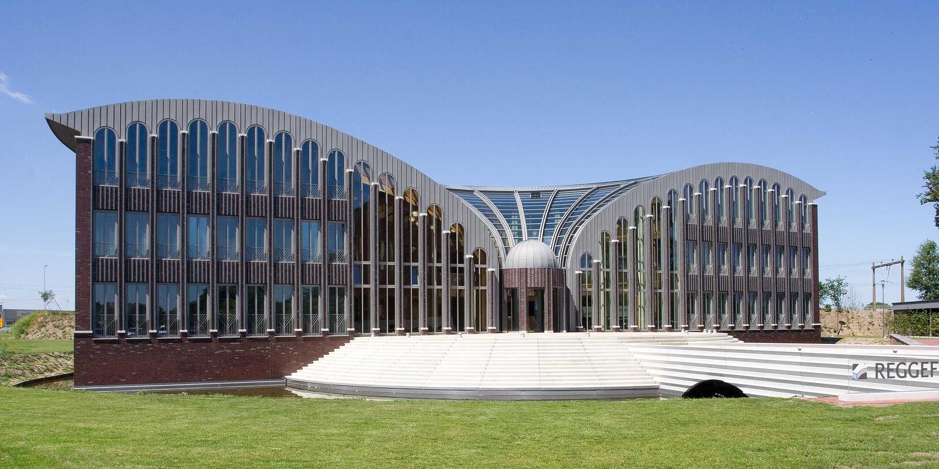 gebouw met rondingen met hout en glas op een grasveld